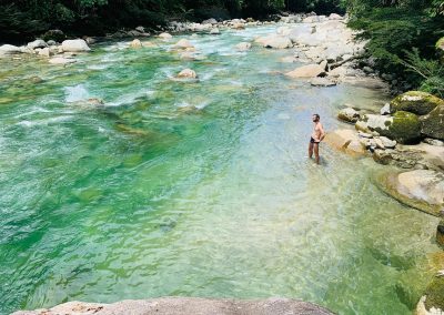 bathing in the sacred river during feather crown ayahuasca retreat in ecuador