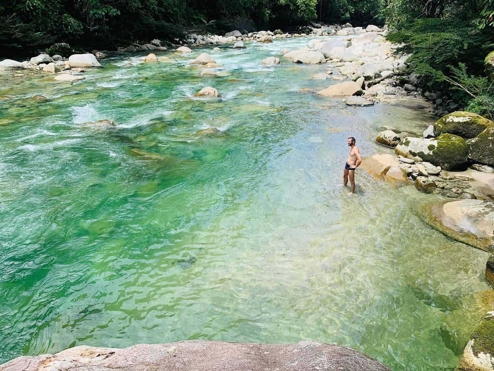 bathing in the sacred river during feather crown ayahuasca retreat in ecuador